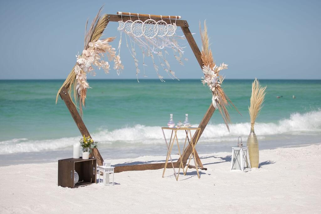 Wooden hexagon arch with a dreamcatcher on the wide sand at Coquina Beach